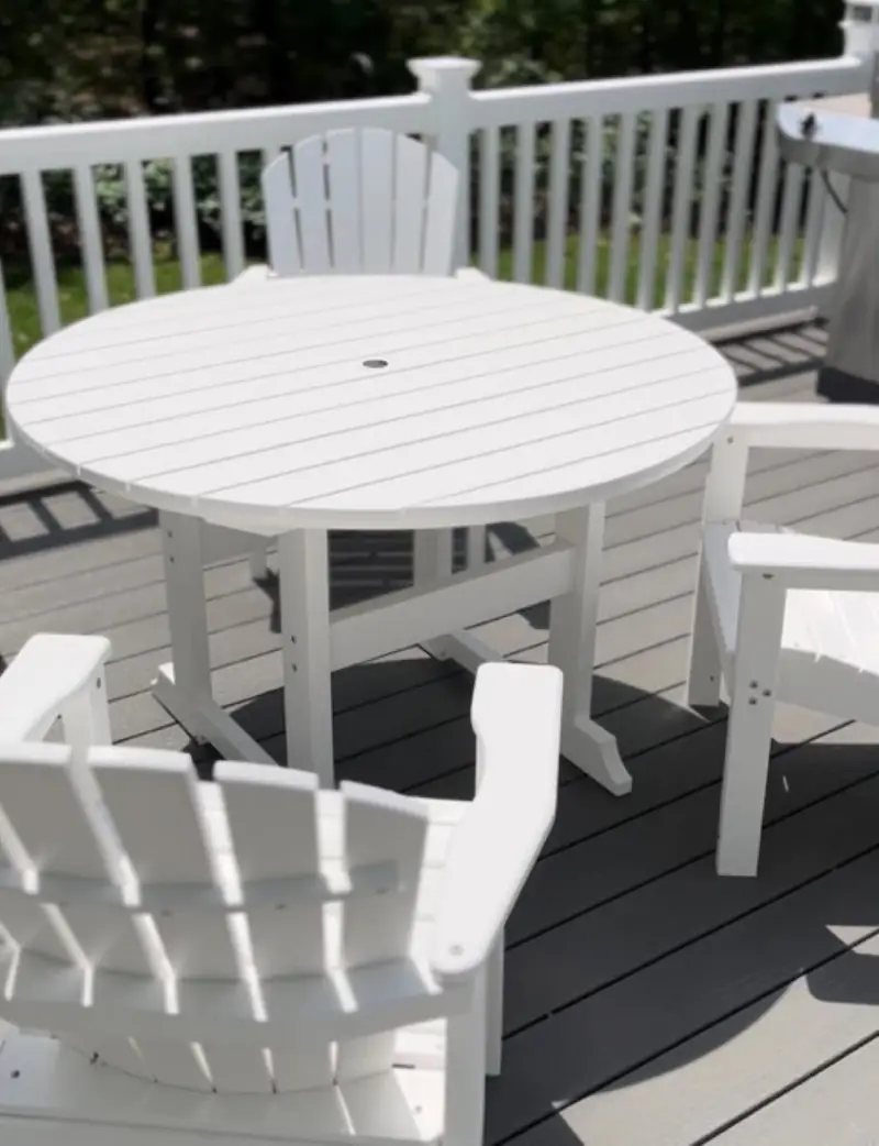 After: the white table and chairs on the deck, clean and bright white